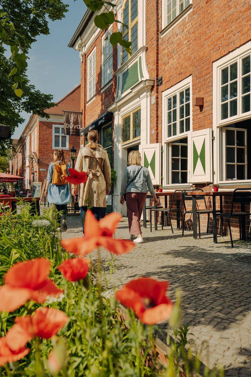 People walking through the Dutch Quarter in Potsdam in spring