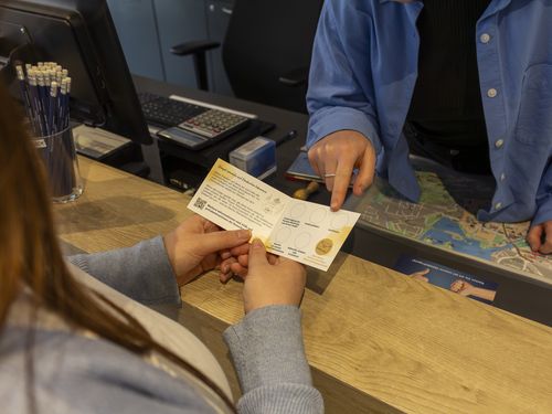 Eine Mitarbeiterin der Tourist Information erklärt die Bonuskarte